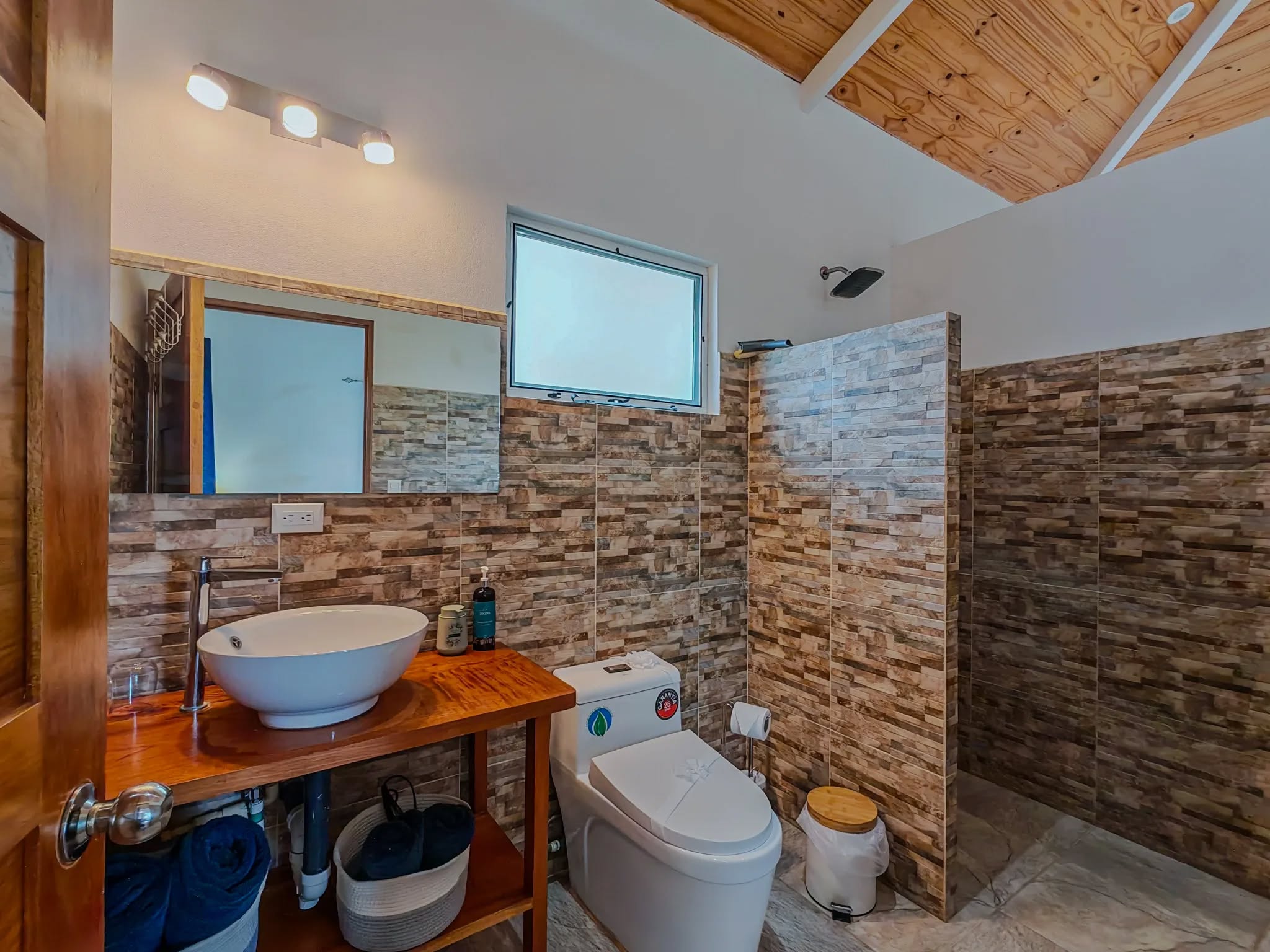 baño con pared de piedra y lavabo moderno infinity retreat